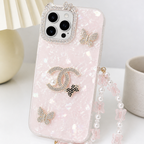 Pink phone case with Chanel logo and butterfly designs on a white surface.